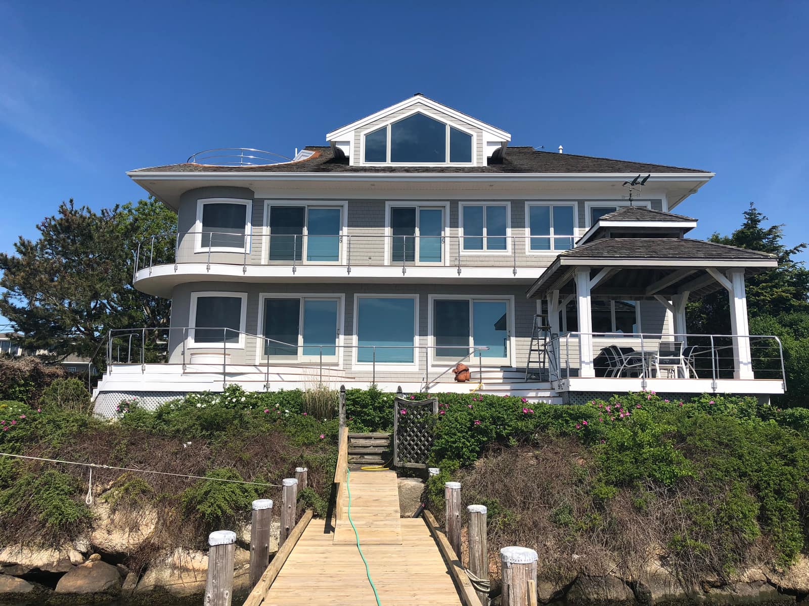 Modern cedar exterior with clean trim and glass railings in Truro