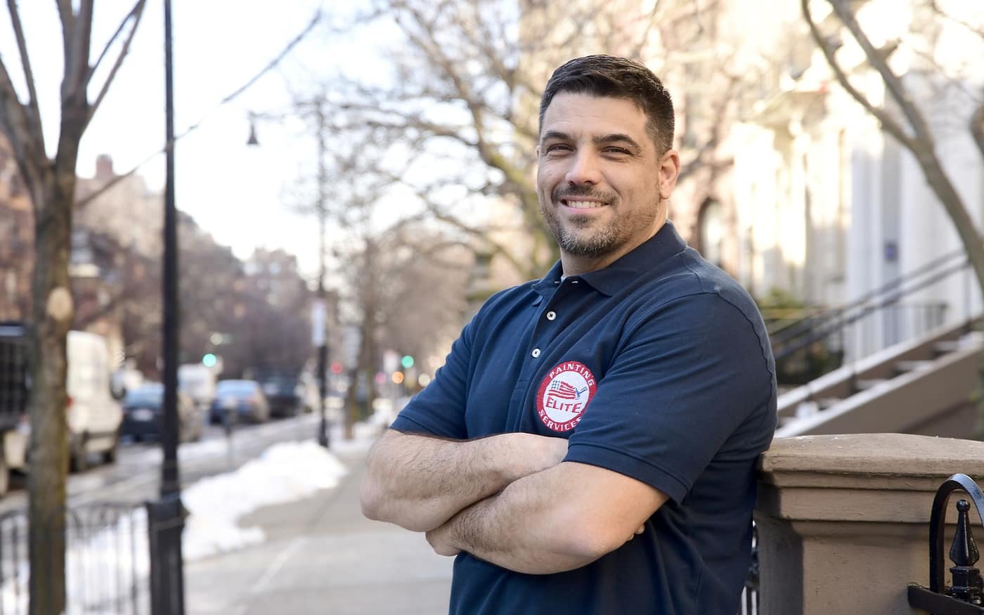 Elite Painting Services team member in branded shirt